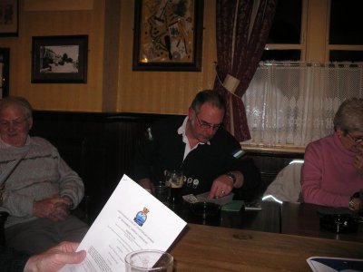 John studying 50th Annual Dinner flyer and Andy checking the funds!